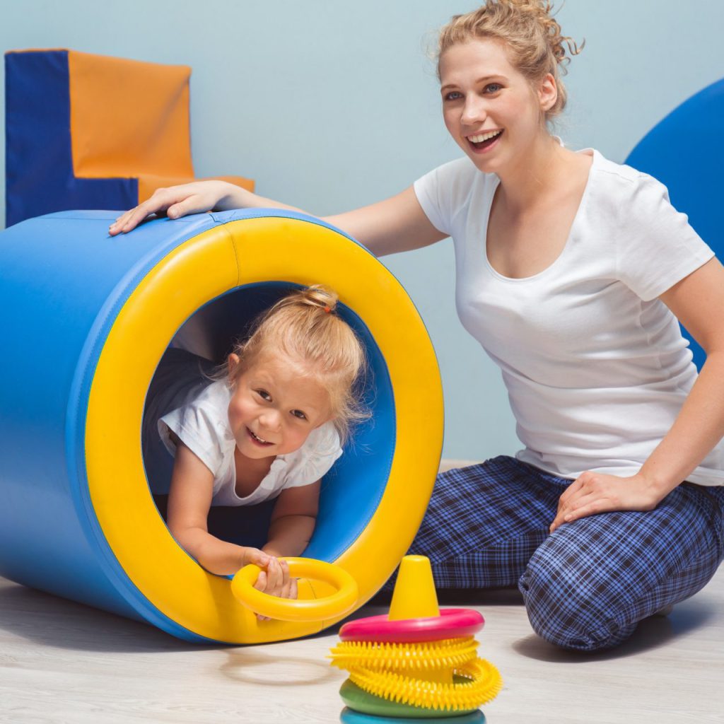 Therapist with the child in a special education therapy session in the best speech and language therapy clinic.