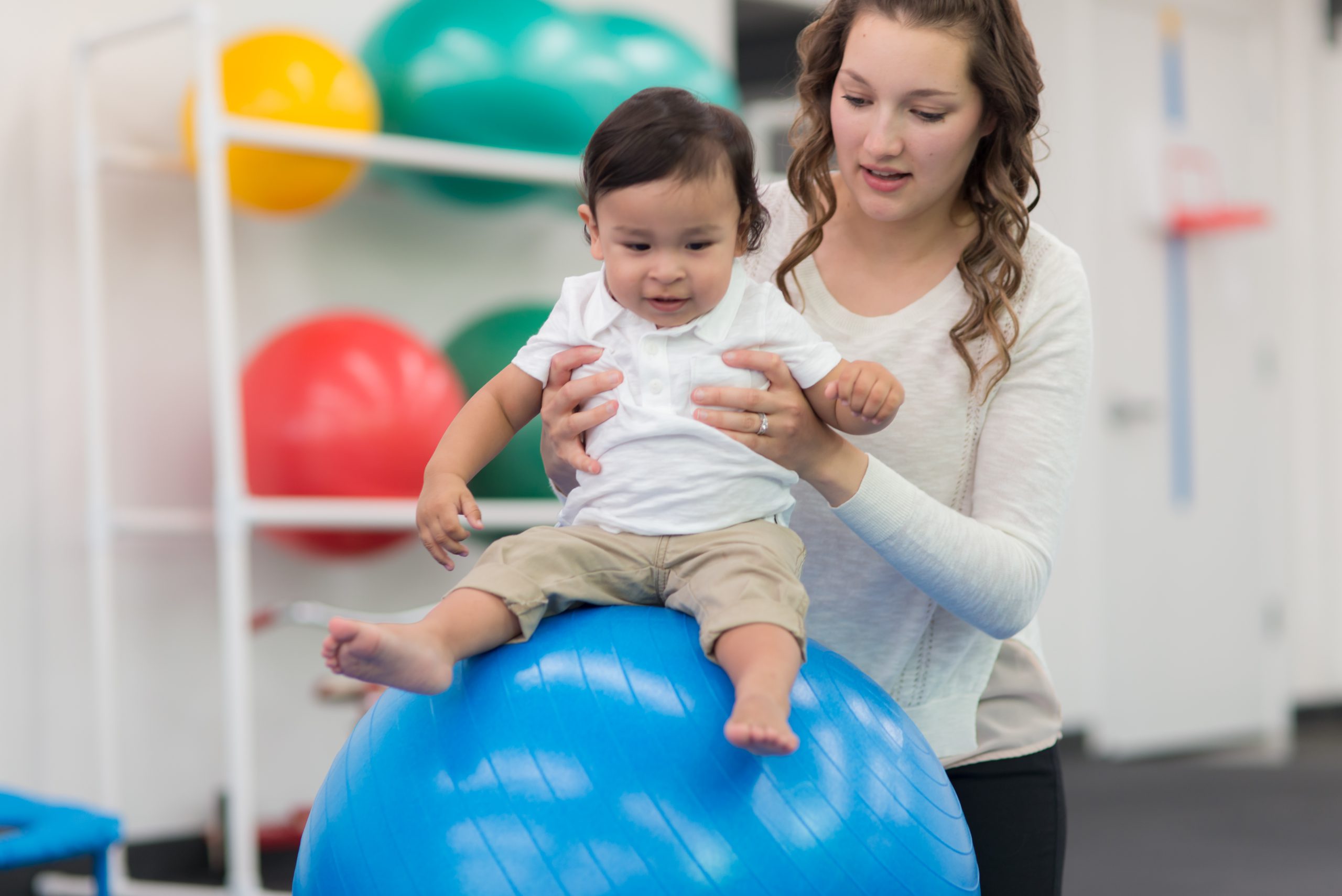 Therapist with kid doing occupational therapy in the best speech and language therapy clinic.