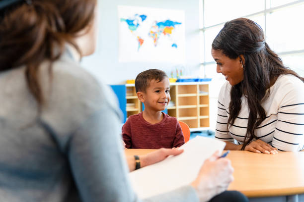 A therapist talks with a boy and his mom during a therapy appointment in the best speech and language therapy clinic.