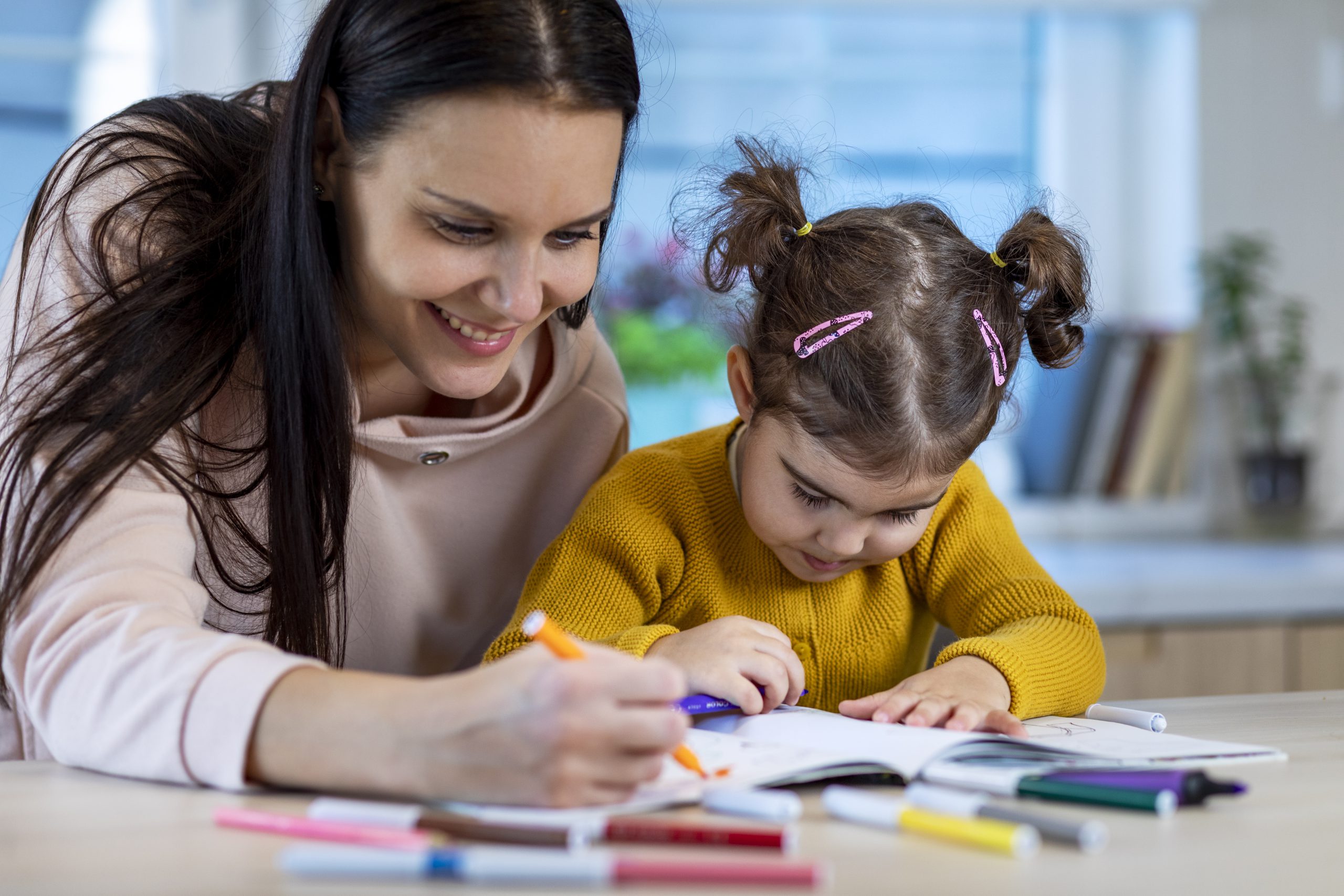 Therapist with the child in a early intervention program therapy session in the best speech and language therapy clinic.