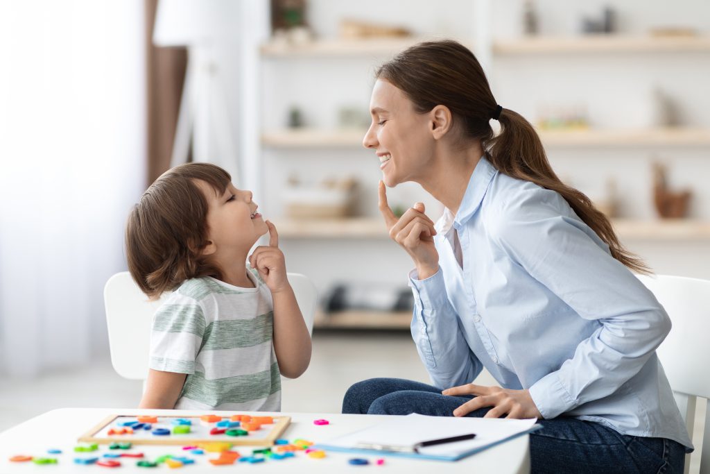 Therapist with child doing speech and language therapy.